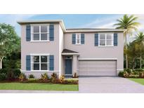 Charming two-story home with blue shutters, a two-car garage, and manicured landscaping at 35138 Valley Ridge Rd, Dade City, FL 33525