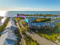 Aerial view of waterfront condos boasting boat docks and stunning water views of the bay and the city skyline at 418 Bahia Beach Blvd, Ruskin, FL 33570