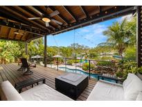 Spacious outdoor deck overlooking a canal with lush landscaping and a resort style pool at 4806 W San Rafael St, Tampa, FL 33629