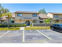 Inviting home exterior featuring manicured landscaping, mature trees, and convenient guest parking at 6262 142Nd N Ave # 1304, Clearwater, FL 33760