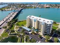 An aerial view of a condo complex in a coastal setting, with a bridge and palm trees nearby at 7862 Sailboat Key S Blvd # 103, South Pasadena, FL 33707