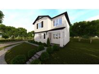 Charming two-story home featuring lush front yard landscaping at 1215 E Broad St, Tampa, FL 33604