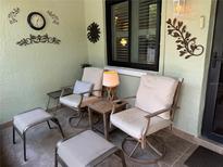 Inviting outdoor patio with comfortable seating and decorative wall art, ideal for relaxation at 20857 Haulover Cv # 1, Lutz, FL 33558