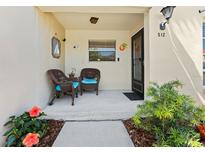 Inviting front porch with comfortable wicker chairs and tasteful nautical decor at 2700 Bayshore Blvd # 512, Dunedin, FL 34698