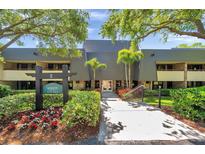 Attractive building exterior with mature landscaping and easy access to all units at 36750 Us 19 N # 2763, Palm Harbor, FL 34684