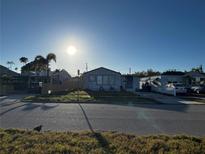 Street view showing a modest single-story home with tidy landscaping and a sunny sky at 4005 Sunrise S Dr, St Petersburg, FL 33705