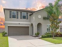 Charming two-story home featuring a well-maintained front yard and a two-car garage at 5210 Dandelion St, Apollo Beach, FL 33572