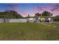 Charming home with a well-manicured lawn and a white fence, creating a welcoming and private outdoor space at 7401 35Th N Ave, St Petersburg, FL 33710