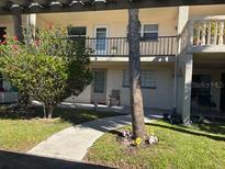 Charming condo featuring well-maintained landscaping, an inviting walkway, and a second-story balcony at 11720 Park Blvd # 104, Seminole, FL 33772