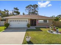 Charming single story home with a well manicured lawn, flower garden, and two car garage at 11803 70Th St, Largo, FL 33773