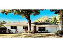 Charming single-story home with a manicured lawn and mature tree offering curb appeal at 2114 Indian N Ave, Belleair Bluffs, FL 33770