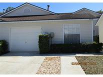 Charming one-story home featuring a one-car garage and tidy landscaping at 21537 Clubside Loop, Lutz, FL 33549