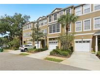 Charming townhome with attached garage, well-maintained landscaping, and a welcoming facade at 3005 Bayshore Pointe Dr, Tampa, FL 33611