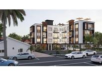 Modern building with balconies, rooftop terrace, and parking in a tropical setting at 702 Pass A Grille Way, St Pete Beach, FL 33706