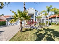 Beautiful two-story home featuring tropical landscaping and a brick-paved driveway at 17927 Bahama Isle Cir, Tampa, FL 33647