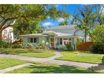 Charming home with beautifully landscaped front yard, walkway, and fresh exterior paint at 2217 Brevard Ne Rd, St Petersburg, FL 33704