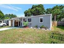 Charming home featuring a well-maintained lawn and light gray siding at 5340 4Th S Ave, St Petersburg, FL 33707