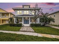 Charming two-story home features a welcoming front yard with a fountain and beautiful landscaping at 5426 Venetian Ne Blvd, St Petersburg, FL 33703