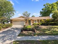 Charming single-story home with stone accents, a well-manicured lawn, and a spacious two-car garage at 5507 Bluejay Ln, Tampa, FL 33625