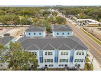 New construction of townhomes with an appealing blue and white exterior at 6605 N Nebraska Ave # 30, Tampa, FL 33604