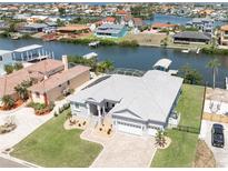 Stunning waterfront home featuring a spacious layout, a private boat dock, and lush landscaping at 819 Birdie Way, Apollo Beach, FL 33572