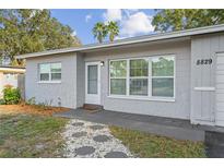 Charming single-story home showcasing updated textured paint, modern windows, and a welcoming entrance walkway at 8829 93Rd St, Seminole, FL 33777