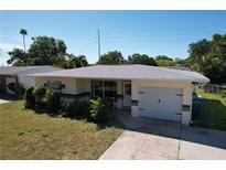 Charming single-story home with a well-maintained lawn and a convenient one-car attached garage at 10754 63Rd Ave, Seminole, FL 33772