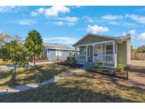 Charming single-story home featuring a cozy front porch and well-manicured landscaping at 1160 36Th N Ave, St Petersburg, FL 33704