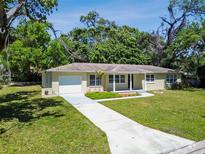 Charming single-story home featuring a well-manicured lawn and an attached one-car garage at 1231 27Th S Ave, St Petersburg, FL 33705