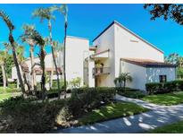 Beautiful two-story condo with a well-manicured lawn and mature tropical landscaping at 2055 Gulf Of Mexico Dr # G2-213, Longboat Key, FL 34228