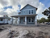 Charming two-story home with a welcoming front porch and stone column bases, a beautiful exterior at 2301 Burlington Ave, St Petersburg, FL 33713