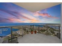 Stunning sunset view from the balcony of this luxury condo, with glass railings and tile flooring at 301 1St S St # 3207, St Petersburg, FL 33701