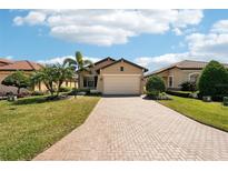 Charming single-story home with a well-manicured lawn and beautiful landscaping at 10612 Glencorse Ter, Bradenton, FL 34211