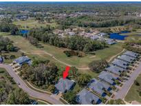 Beautiful aerial view of a charming home with a golf course view in a serene community at 11719 Foxworth Ln, New Port Richey, FL 34654