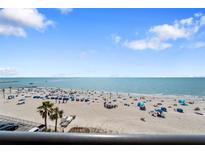 Expansive beach view with white sand and turquoise water, perfect for relaxation and recreation at 12924 Gulf Blvd # 502, Madeira Beach, FL 33708