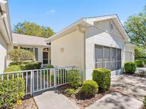 Inviting home exterior with well-manicured landscaping and a charming gated walkway leading to the entrance at 2618 Newcomb Ct # 12, Sun City Center, FL 33573