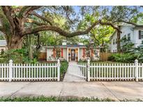 Charming single-story home with a white picket fence and lush landscaping offers curb appeal at 2624 W Prospect Rd, Tampa, FL 33629