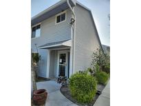 Charming two-story home showcasing new grey siding, manicured landscaping, and inviting entrance at 500 New York Ave # 21, Dunedin, FL 34698