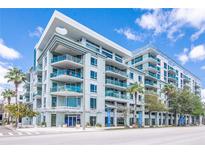 A modern condo building featuring stylish architecture, balconies, and lush landscaping at 111 N 12Th St # 1426, Tampa, FL 33602