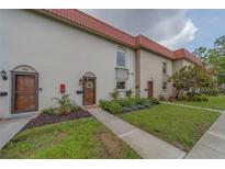 Charming townhome with red tile roof, updated landscaping, and decorative front door at 2700 Bayshore Blvd # 588, Dunedin, FL 34698