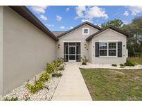 Charming single-story home featuring a screened entryway and well-maintained landscaping at 4307 Dristol Ave, Spring Hill, FL 34609