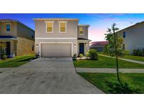 Two-story home with a two-car garage, landscaping, and a concrete driveway at 5758 Hollingworth Trl, Wesley Chapel, FL 33545