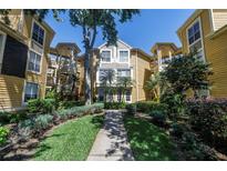 Inviting condo building with lush landscaping and a charming walkway leading to the entrance at 115 112Th Ne Ave # 310, St Petersburg, FL 33716