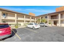 Well-maintained building exterior with palm trees and parking for residents and visitors under a clear blue sky at 19029 Us Highway 19 N # 6-3, Clearwater, FL 33764