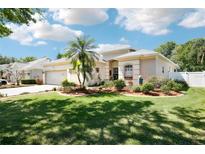 Well-maintained single-story home featuring a lush green lawn and attractive landscaping at 3503 Williston Loop, Land O Lakes, FL 34639