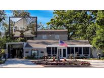 Charming single Gathering home with covered parking, well-manicured lawn and an American flag at 6166 9Th N Ave, St Petersburg, FL 33710