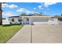 Charming single-story home featuring a well-manicured lawn and inviting front entrance at 7097 Aberfeldy N Ave, St Petersburg, FL 33709