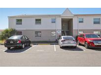 A two-story condo building with visitor parking and a tidy exterior at 7210 N Manhattan Ave # 1721, Tampa, FL 33614