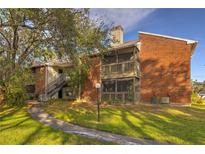 Charming two-story condo with brick facade, screened balconies, and lush landscaping at 9100 Dr Martin Luther King Jr N St # 1706, St Petersburg, FL 33702