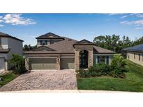 Charming home featuring a beautiful brick driveway and a meticulously landscaped front yard at 9133 Warm Springs Cir, Parrish, FL 34219